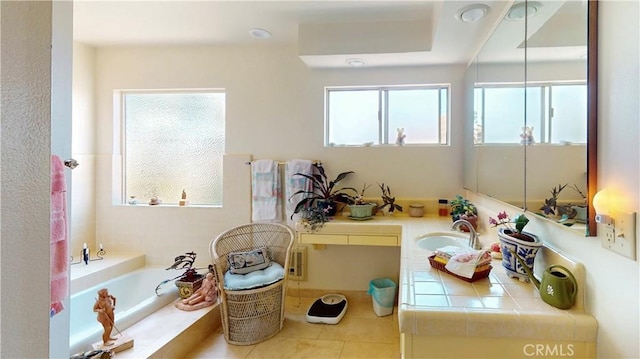 full bath featuring a garden tub and a sink