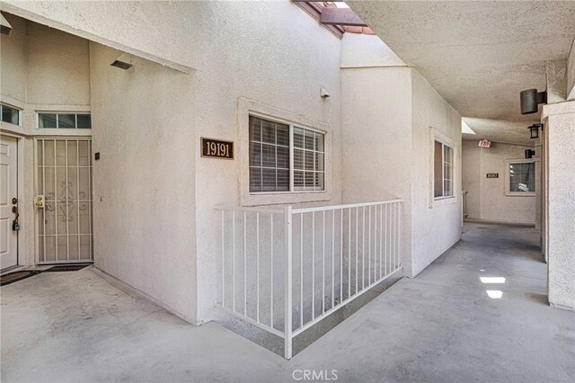 property entrance featuring a patio area and stucco siding