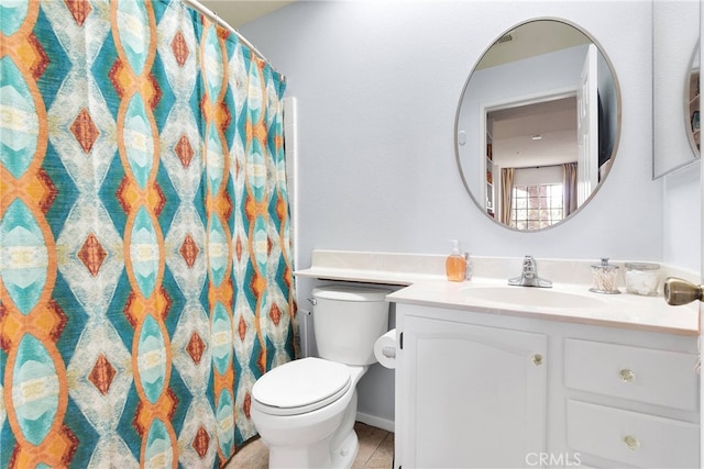 bathroom with curtained shower, vanity, and toilet