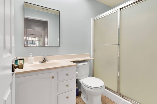 full bath with a stall shower, vanity, toilet, and tile patterned floors