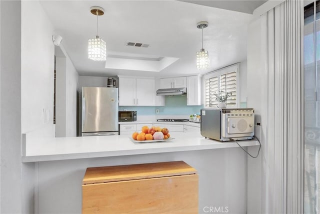 kitchen with under cabinet range hood, visible vents, white cabinets, light countertops, and black appliances