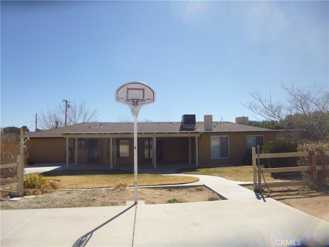 back of property with central AC, a lawn, and fence