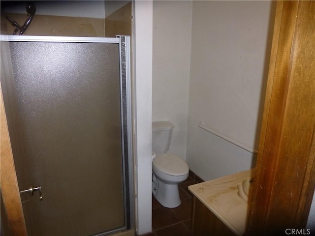 full bath featuring a stall shower, vanity, toilet, and tile patterned floors