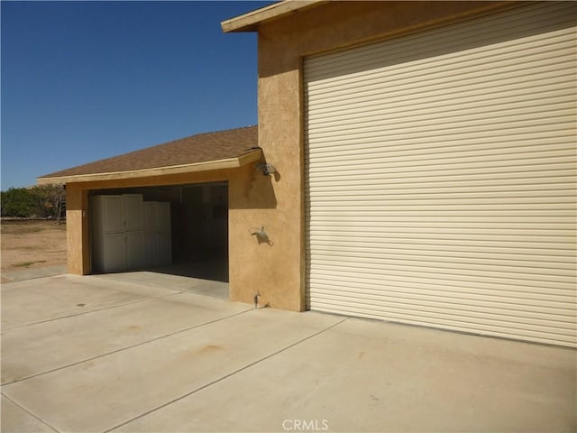 garage featuring concrete driveway