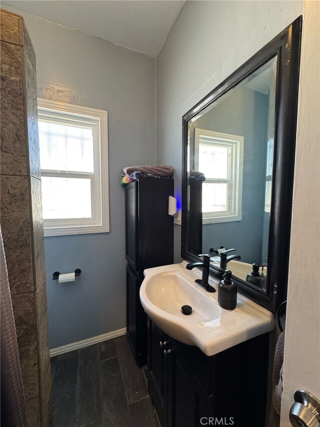 1375 E 46th St, Los Angeles, CA 90011 - bathroom with vanity, baseboards, and wood finished floors