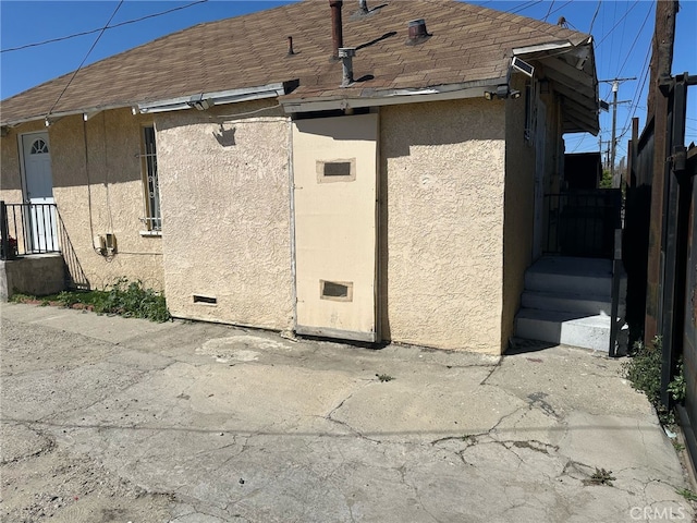 1375 E 46th St, Los Angeles, CA 90011 - view of property exterior featuring crawl space, roof with shingles, and stucco siding
