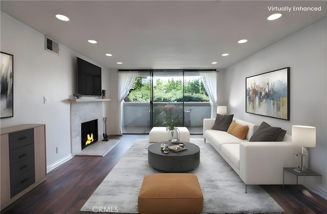 living room featuring a fireplace, dark wood-style flooring, and recessed lighting