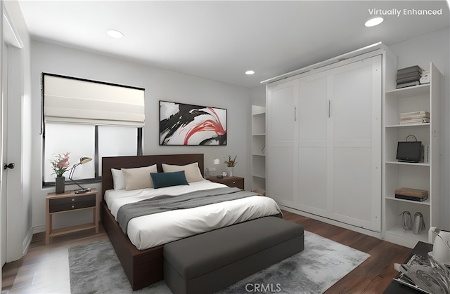 bedroom with recessed lighting and wood finished floors