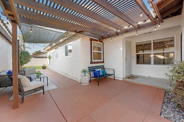 view of patio / terrace featuring fence, an outdoor living space, and a pergola