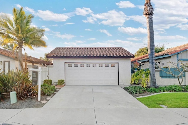 mediterranean / spanish home featuring a tiled roof and stucco siding