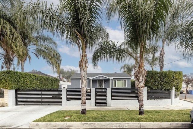 view of front of property with a fenced front yard, a gate, and stucco siding