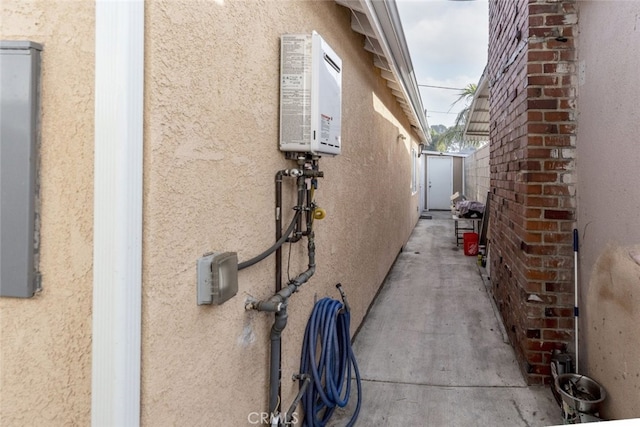 view of side of property featuring fence and stucco siding