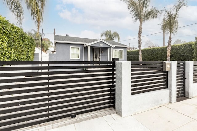 view of gate with a fenced front yard