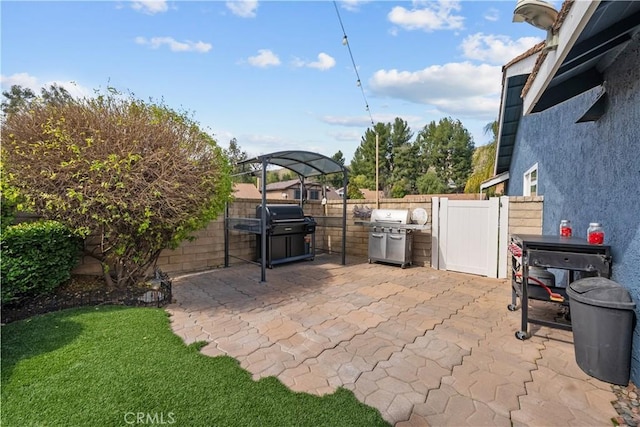 view of patio / terrace with a fenced backyard and a grill