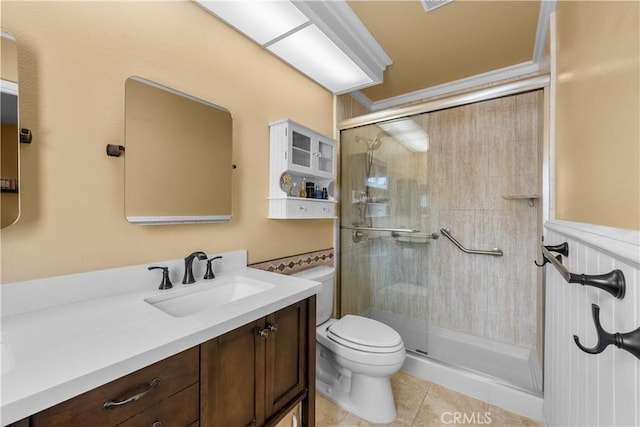 bathroom featuring vanity, a shower stall, toilet, and tile patterned floors