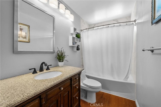 bathroom featuring toilet, shower / bath combo with shower curtain, wood finished floors, and vanity