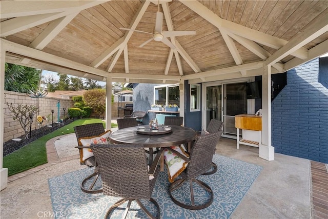 view of patio / terrace with outdoor dining area, a fenced backyard, and a gazebo