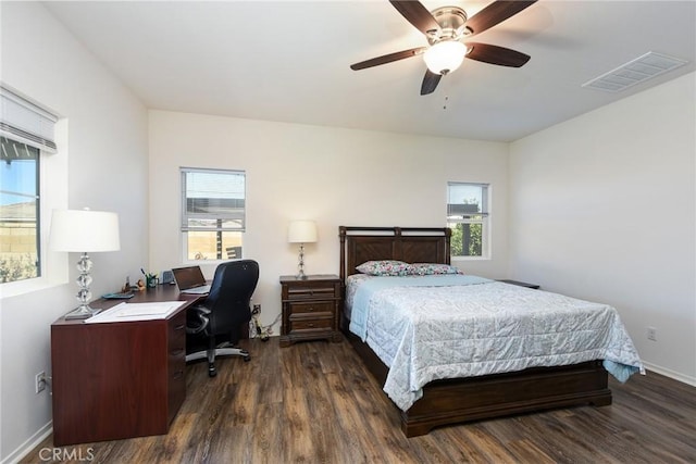 bedroom with multiple windows, visible vents, and dark wood-style flooring