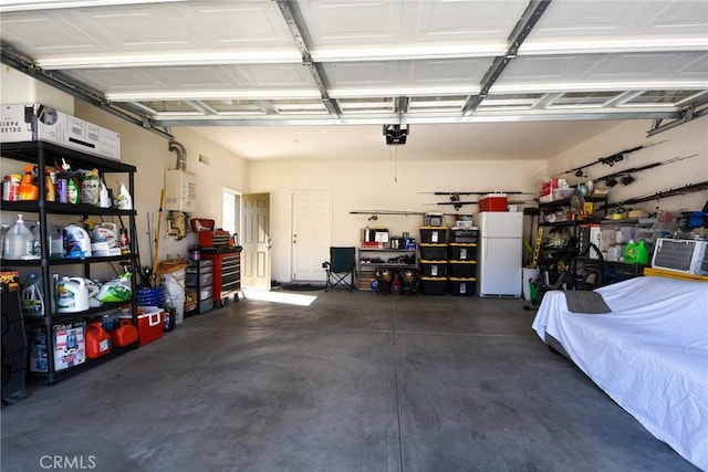 garage with a garage door opener, tankless water heater, and freestanding refrigerator