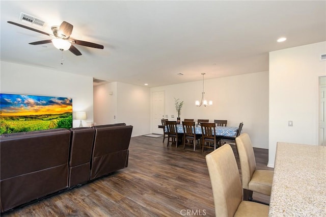 living room featuring recessed lighting, dark wood-style flooring, visible vents, and ceiling fan with notable chandelier