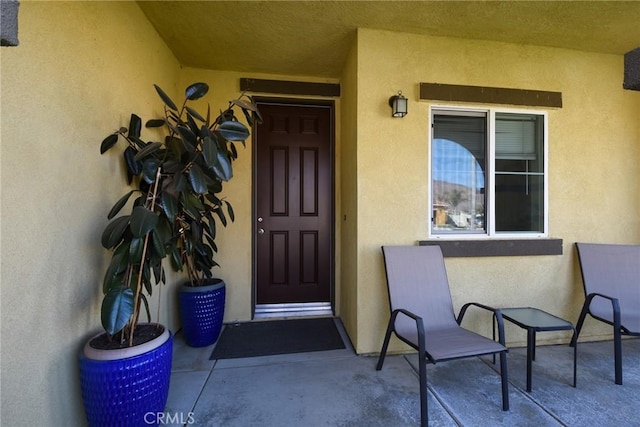 doorway to property with stucco siding