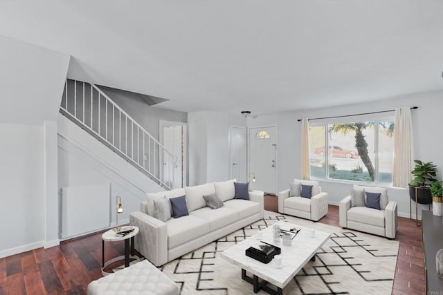 living area featuring stairway, wood finished floors, and baseboards