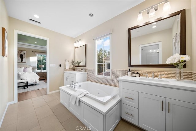 bathroom with visible vents, ensuite bath, a sink, tile patterned flooring, and two vanities