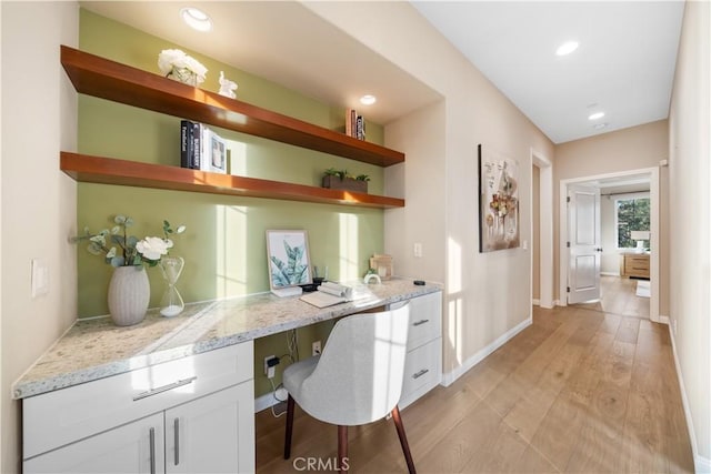 office space featuring baseboards, light wood-type flooring, built in study area, and recessed lighting