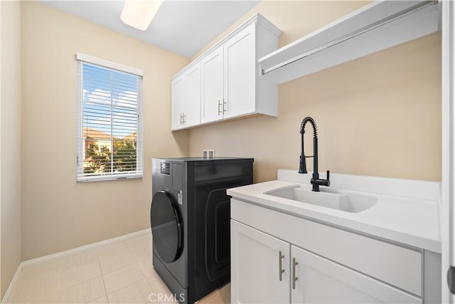 laundry area with washer / dryer, cabinet space, a sink, and baseboards