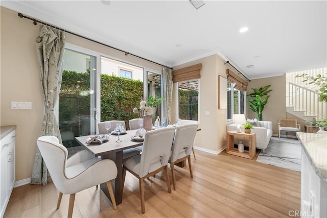 dining space featuring ornamental molding, light wood-type flooring, baseboards, and recessed lighting