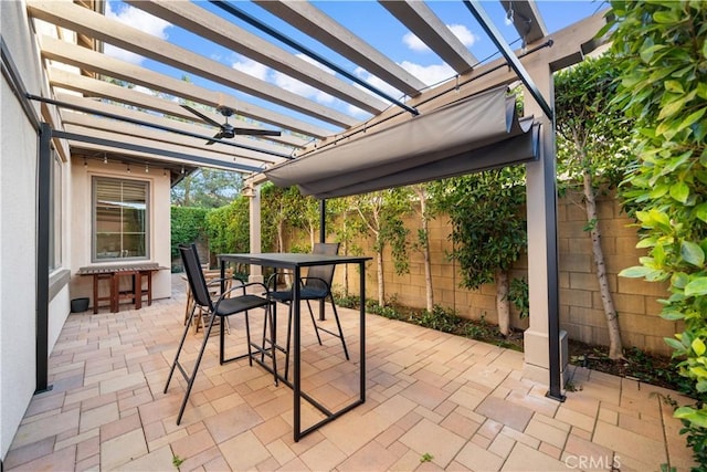 view of patio / terrace with a fenced backyard, a ceiling fan, a pergola, and outdoor dining space