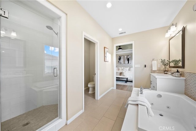 full bathroom featuring connected bathroom, toilet, vanity, visible vents, and a whirlpool tub