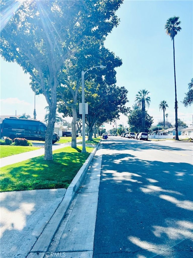 view of street with curbs, street lighting, and sidewalks