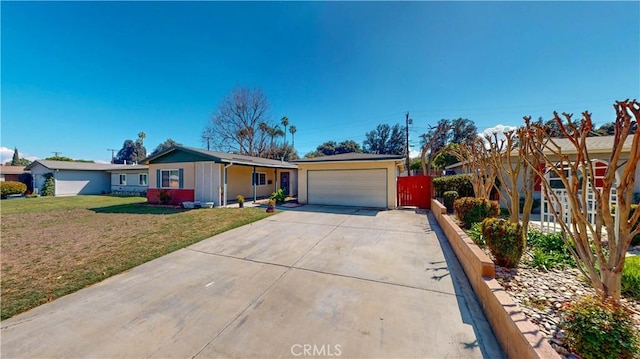 ranch-style house featuring a garage, driveway, and a front lawn