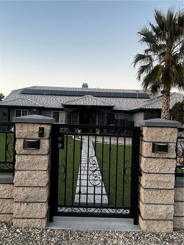 view of gate with a yard