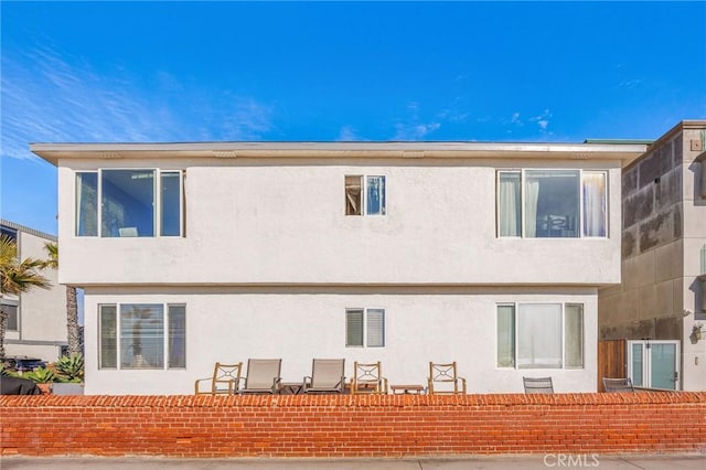 back of house featuring stucco siding