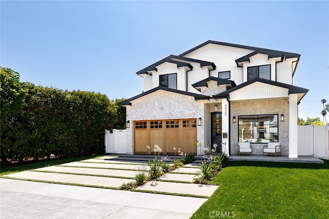 modern farmhouse featuring a garage, stone siding, fence, and a front lawn