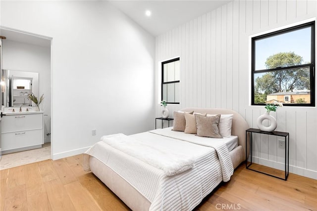 4435 Katherine Ave, Sherman Oaks, CA 91423 - bedroom featuring light wood finished floors, a sink, ensuite bathroom, baseboards, and lofted ceiling