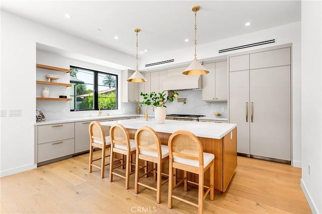 4435 Katherine Ave, Sherman Oaks, CA 91423 - kitchen with recessed lighting, tasteful backsplash, light wood finished floors, and light countertops