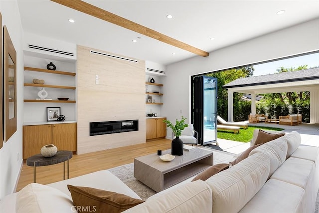 4435 Katherine Ave, Sherman Oaks, CA 91423 - living room featuring recessed lighting, a tile fireplace, wood finished floors, a wall mounted AC, and built in shelves
