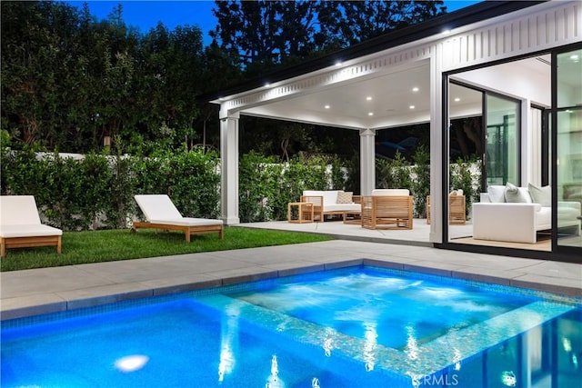 outdoor pool with a patio and an outdoor hangout area