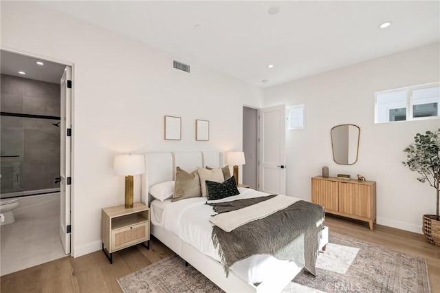 bedroom with light wood-style floors, baseboards, and visible vents