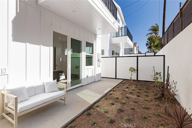 view of patio featuring outdoor lounge area and fence