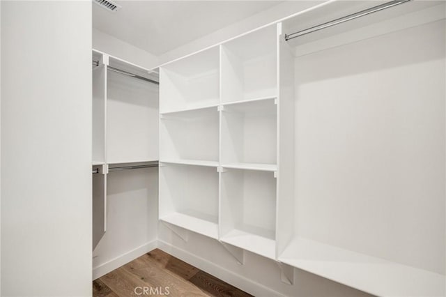 walk in closet featuring wood finished floors and visible vents