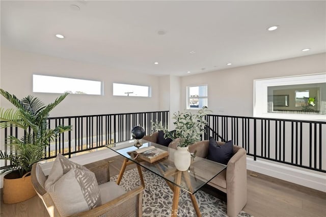 living room with baseboards, wood finished floors, and recessed lighting