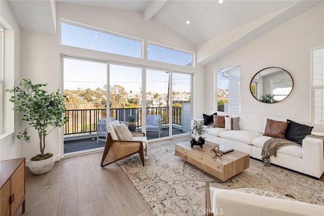 living area with high vaulted ceiling, beamed ceiling, wood-type flooring, and recessed lighting