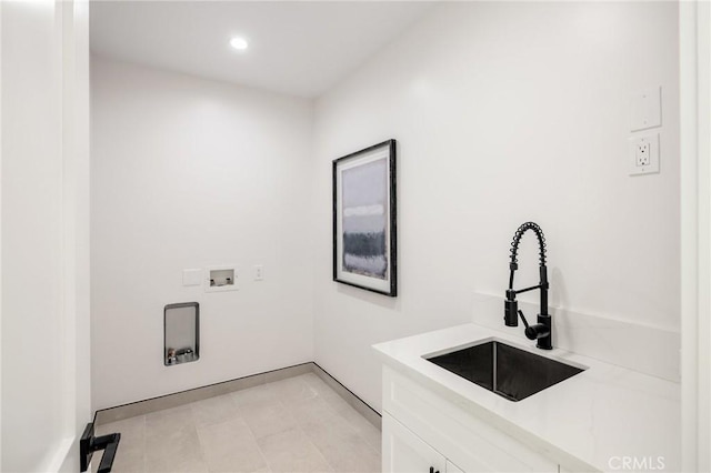 laundry room with hookup for a washing machine, recessed lighting, cabinet space, and a sink