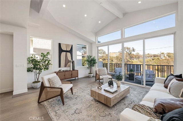 living area with beam ceiling, recessed lighting, light wood-style flooring, high vaulted ceiling, and baseboards