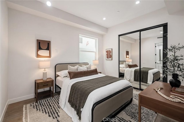 bedroom featuring recessed lighting, a closet, baseboards, and wood finished floors