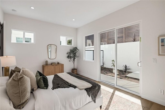 bedroom featuring baseboards, access to outside, wood finished floors, and recessed lighting